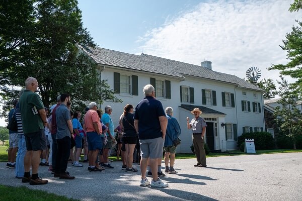 Ranger with visitors in front of the home at Eisenhower National Historic Site in Gettysburg, PA
