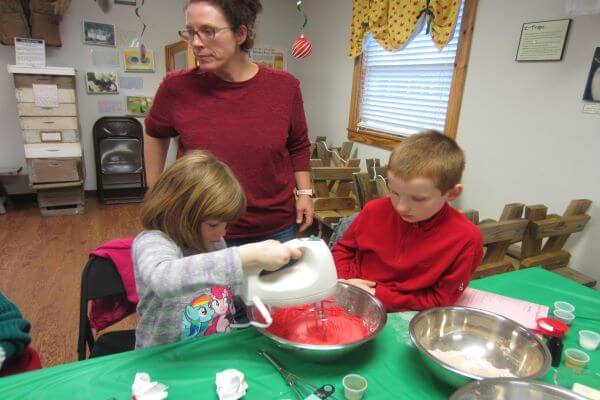 mom and children making Christmas icing