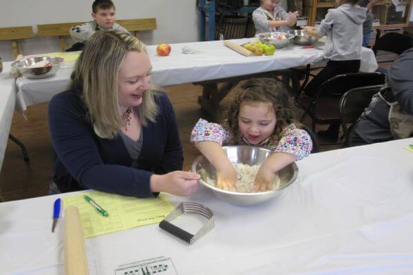 girl and mother mixing pie dough