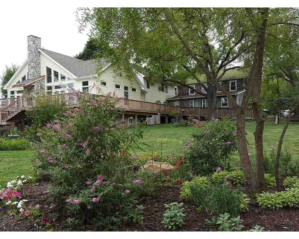 Spend A Day in Haunted Gettysburg The Battlefield Bed and Breakfast Inn surrounded by a serene landscape during the summer.