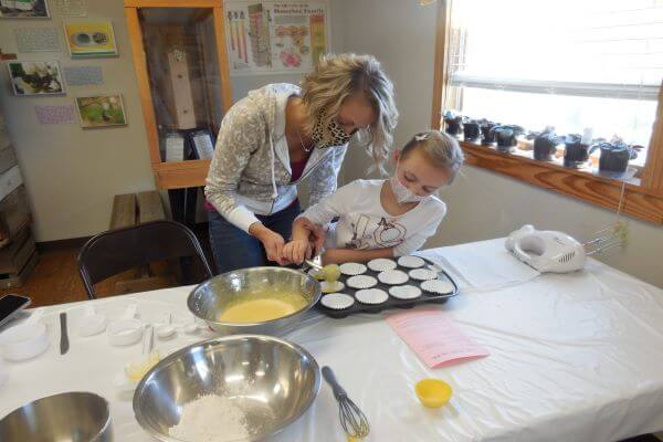 mother and daughter making cupcakes